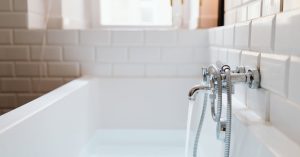 Bathtub with water running from faucet