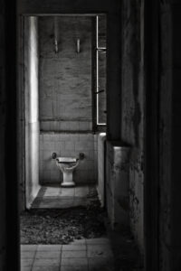 dark corridor with a toilet at the end of it