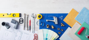 Plumber's work table banner with work tools, faucet, tiles and color swatches, top view