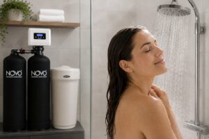 Person taking a shower enjoying reduced chlorine in water